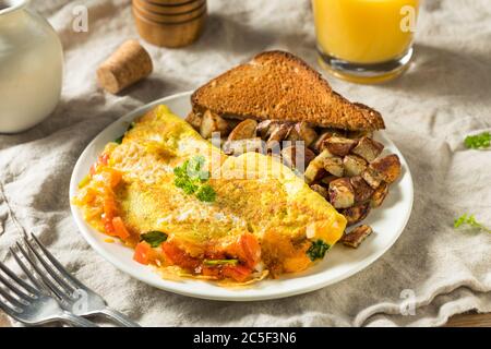 Homemade Veggie Omelette with Cheese Potatoes and Toast