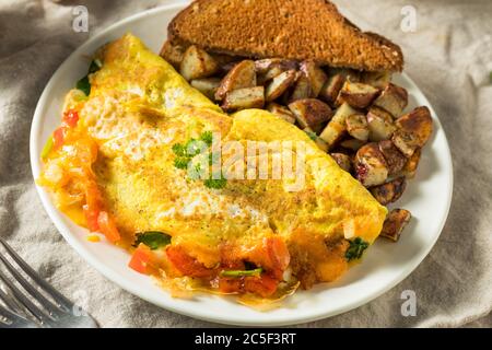 Homemade Veggie Omelette with Cheese Potatoes and Toast