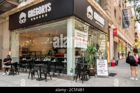 Customers enjoy outdoor seating at the re-opened Gregorys Coffee in Chelsea in New York on Friday, May 29, 2020.  NYS Gov. Andrew Cuomo announced thatthe  indoor seating of Phase 3 has been postponed due to non-compliance with social distancing protocols.  (© Richard B. Levine) Stock Photo
