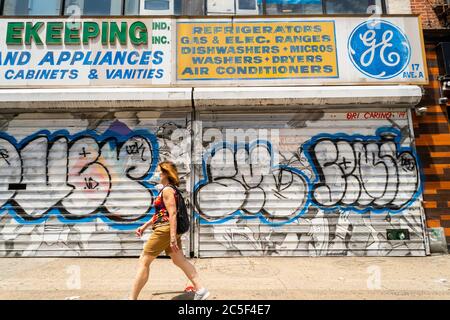 The General Electric “GE” logo appears on a privilege sign on an appliance store in the East Village neighborhood of New York on Saturday, May, 30, 2020. General Electric sold their appliance business to Haier in 2016 and recently divested its lightbulb business which was its last consumer unit. (© Richard B. Levine) Stock Photo