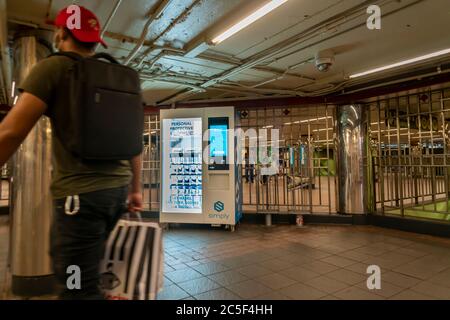 A vending machine in the Herald Square subway station in New York on Tuesday, June 30, 2020 sells PPE merchandise to riders. The MTA has placed twelve vending machines selling personal protective equipment and hand sanitizer in 10 major stations in the system. Masks are required to ride subways and busses. © Richard B. Levine) Stock Photo