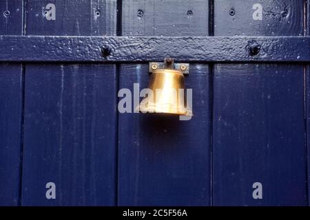 Traditional old door bell for ring on old wooden door, vintage background textue Stock Photo