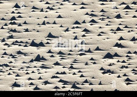 wind and water created sand texture on the seashore Stock Photo