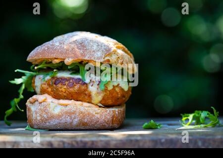 Pork and chorizo burger with cheese in a bun Stock Photo