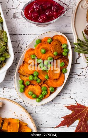 Glazed roasted carrot with peas Stock Photo