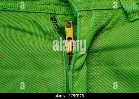 Men's jeans are red with a yellow zipper. Casual modern and fashionable clothing. The upper part of the pants. Creative minimal style. The view from Stock Photo
