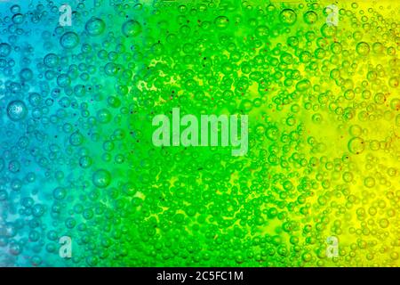 Abstract textured background transparent blue, green and yellow gel. Soft focus. Stock Photo