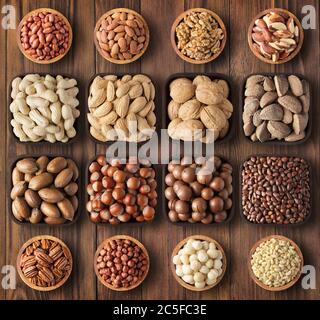 peeled and shelled nuts on background wooden table. composition health food: pecans, hazelnuts, walnuts, almonds, macadamia, peanuts, pine, brazilian Stock Photo