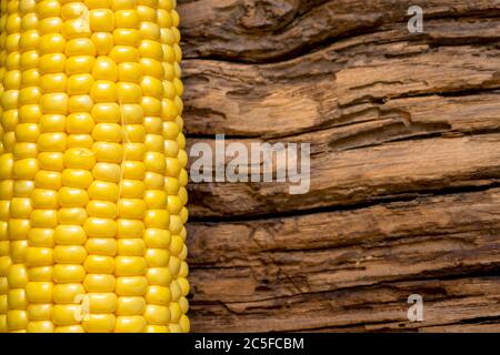 Corn isolated on wooden background Stock Photo