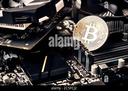 Bitcoin. New virtual money. Bitcoins lie on the video card, concept of mining. Stock Photo