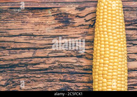 Corn isolated on wooden background Stock Photo