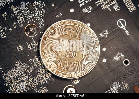 Bitcoin. New virtual money. Bitcoins lie on the video card, concept of mining. Stock Photo