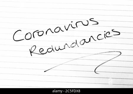 CORONAVIRUS REDUNDANCIES written on lined paper Stock Photo