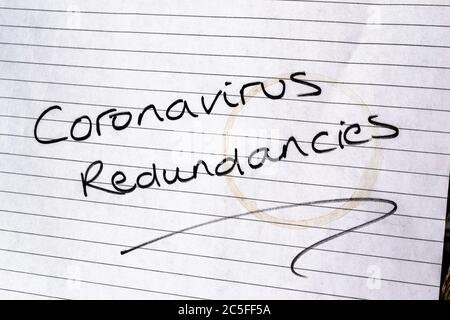 CORONAVIRUS REDUNDANCIES written on lined paper Stock Photo