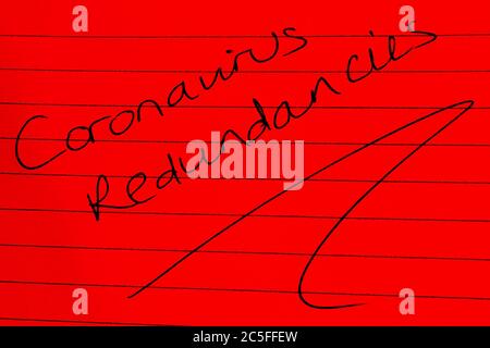 ‘Coronavirus redundancies’ written on lined paper Stock Photo