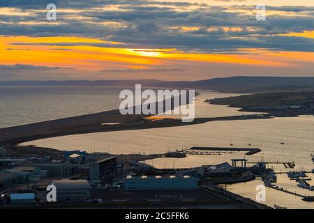 Isle of Portland, Dorset, UK.  2nd July 2020.  UK Weather.  Sunset viewed from the Isle of Portland in Dorset looking along Chesil Beach and The Fleet lagoon on the Jurassic Coast.  Picture Credit: Graham Hunt/Alamy Live News Stock Photo