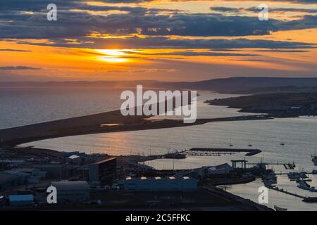 Isle of Portland, Dorset, UK.  2nd July 2020.  UK Weather.  Sunset viewed from the Isle of Portland in Dorset looking along Chesil Beach and The Fleet lagoon on the Jurassic Coast.  Picture Credit: Graham Hunt/Alamy Live News Stock Photo