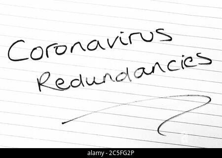 CORONAVIRUS REDUNDANCIES written on lined paper Stock Photo