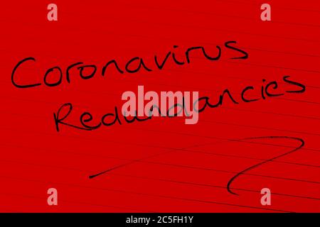 ‘Coronavirus redundancies’ written on lined paper Stock Photo