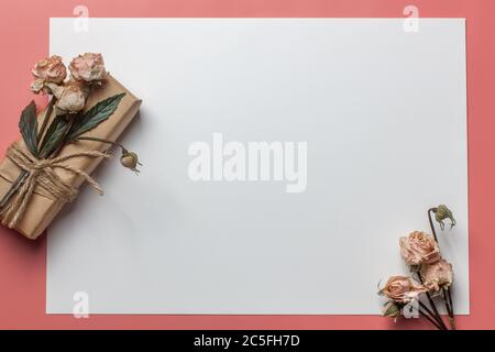 Flowers composition. Workspace with small bouquet and gift Top view, flat lay Stock Photo