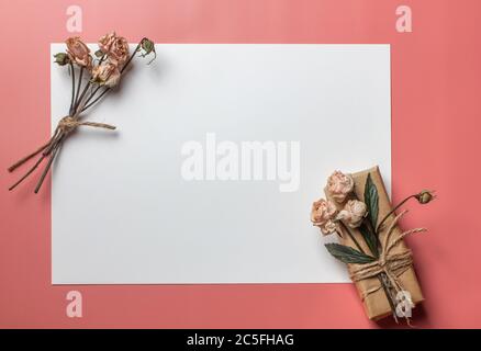Flowers composition. Workspace with small bouquet and gift Top view, flat lay Stock Photo