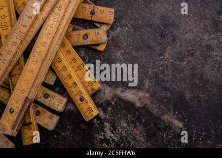 old tools, hammer, chisel, spatula measuring tape and brushes greasy and dirty heavily rusted lie on a metal dark background Stock Photo