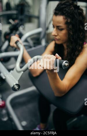 Portrait of sporty woman working out in gym. Stock Photo