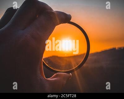Taking photos of sunset through the camera filter inside nature Stock ...