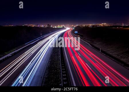 Highway light car trails leading from passing cars during night. Stock Photo