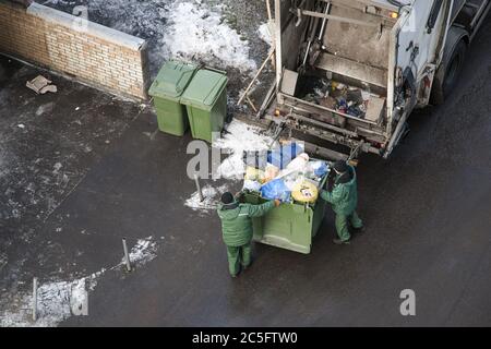 Overloaded dumpster, full garbage container, household garbage b