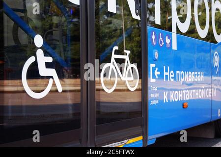 Moscow 06/06/2019 City electric bus, close-up of glass doors and side view with icons for disabled person, bicycle, elderly person and pram. Environme Stock Photo