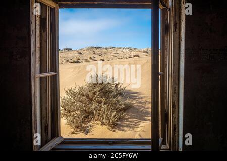 An open window on an old rundown house , Kolmanskop, Karas Region, Namibia Stock Photo