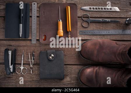 Leather Working Tools And Rolled Up Hide Organized Stock Photo