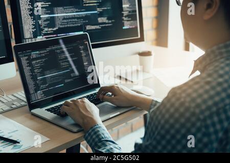 Asian man working development of programming and encryption technology website design programmers on desk in office. Stock Photo