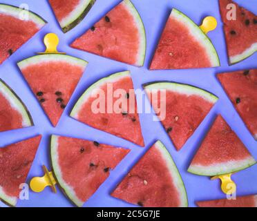 Pattern of watermelon slices on an ice cream stick on a blue background. Creative idea Stock Photo