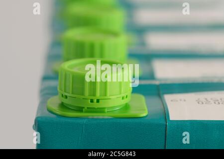 Packaging, plastic, row of bottle tops, green bottle cap, screw caps, UHT, long life, group of objects, recycling, plastic pollution Stock Photo
