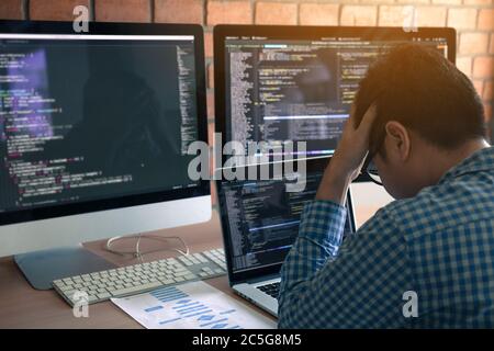 Software developers headache with code analysis in the office. Stock Photo