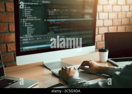 Close up of hands contemporary website developer man typing and writing code for program website. Stock Photo