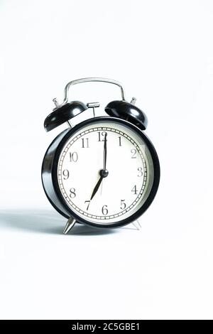A black alarm clock isolated against white background Stock Photo - Alamy