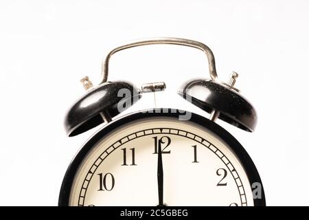 A black alarm clock isolated against white background Stock Photo