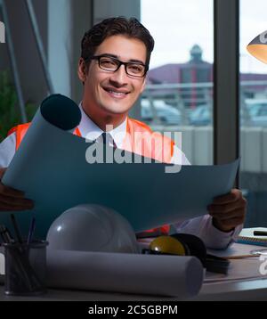The construction architect working on drawings late at night Stock Photo