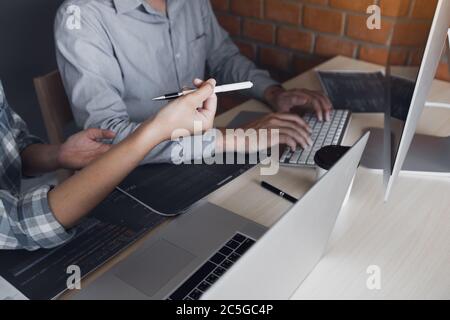 Developing programming and coding technologies working in a software engineers developing applications together in office. Stock Photo