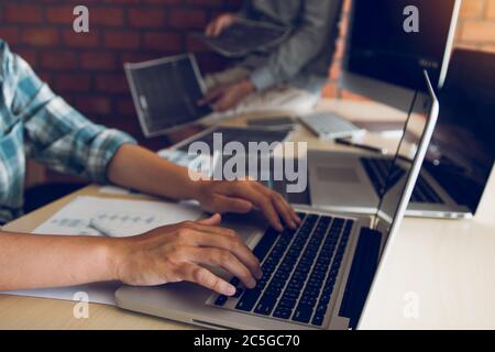 Two software developers are analyzing together about the code written into the program on the computer. Stock Photo