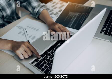 Two software developers are analyzing together about the code written into the program on the computer. Stock Photo