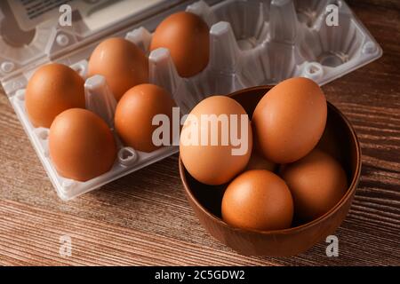 A carton of eggs on a wooden background Stock Photo