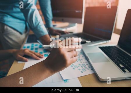 Two software developers are analyzing together about the code written into the program on the computer. Stock Photo