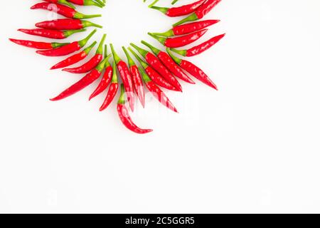 Background of red ripe Thai peppers arranged in a circle with white background and copy space. Stock Photo