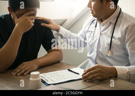Doctor is comforting the patient after notifying the patient about the outcomes of treatment. Stock Photo