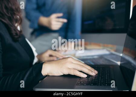 Two software developers are analyzing together about the code written into the program on the computer. Stock Photo