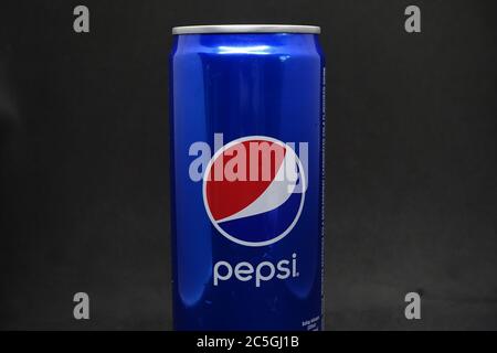 A can of blue pepsi against isolated black background Stock Photo